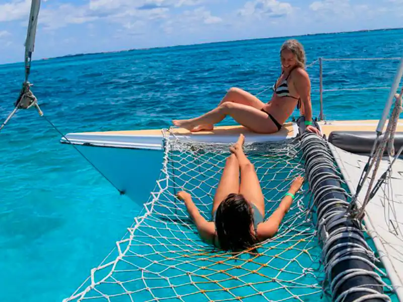 Have a fantastic time on the half day private catamaran sailing tour to Isla Mujeres while relaxing on the catamaran's trampoline and enjoy the view of the turquoise water
